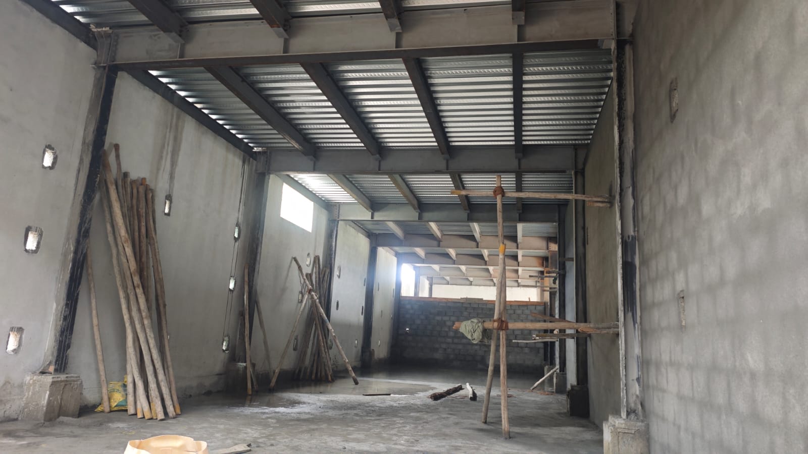 Interior view of a steel-framed structure under construction, Alatues Industries