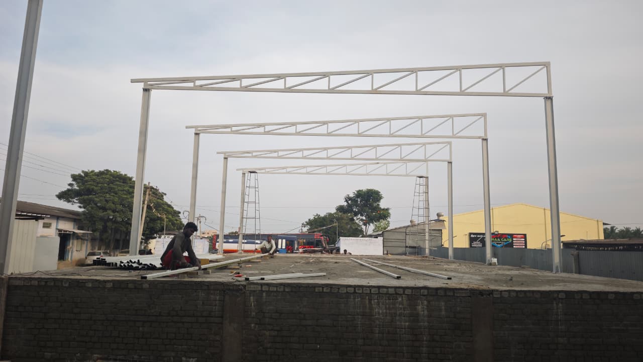 Steel canopy skeleton frame being assembled with support towers
