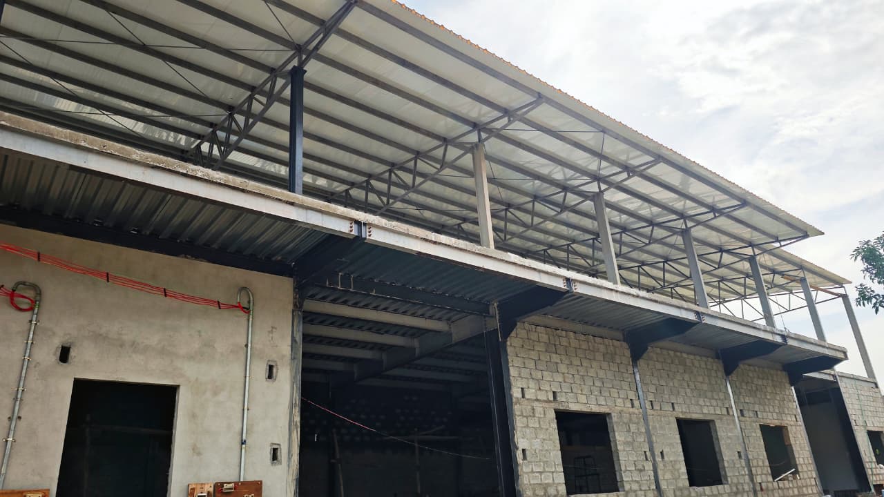Multi-level industrial facility exterior with steel overhang