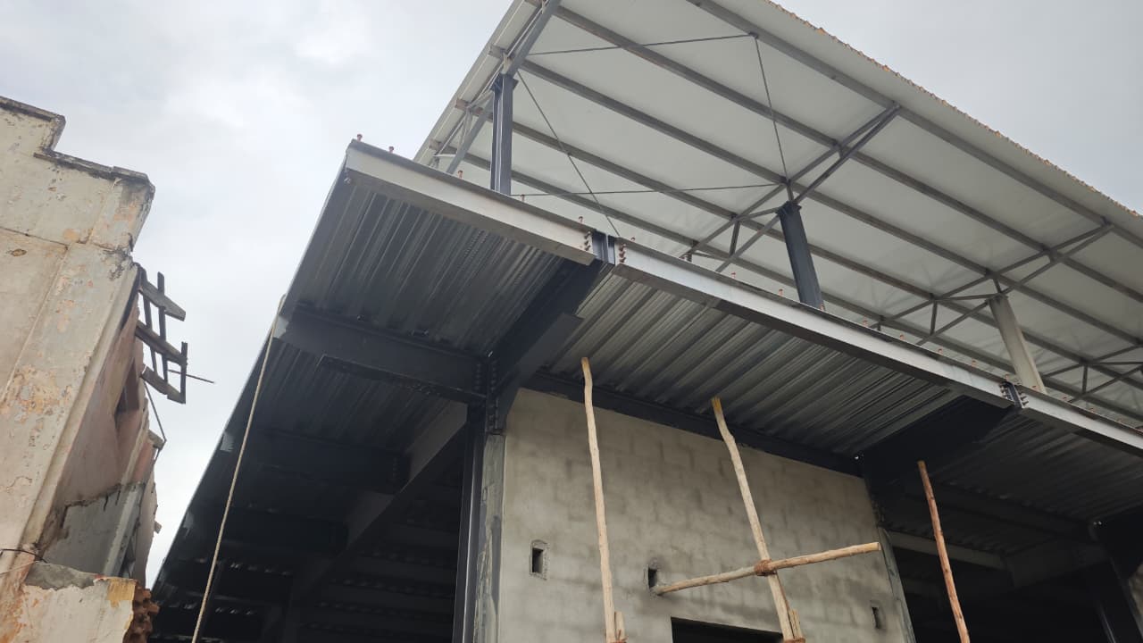 Dramatic upward view of a steel roof overhang structure