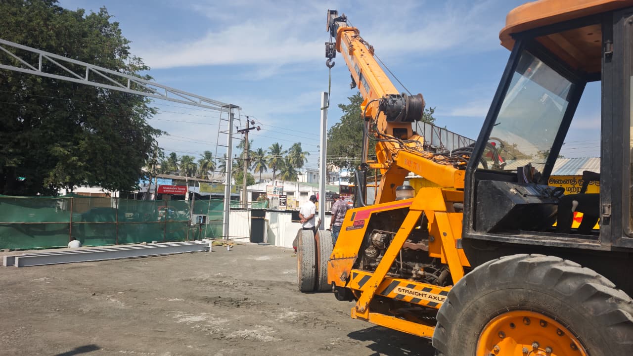 Mobile crane lifting a steel truss into place on site