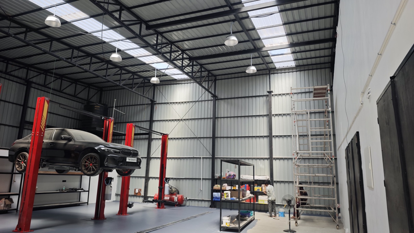 Vehicle service bay interior with steel structure and skylights