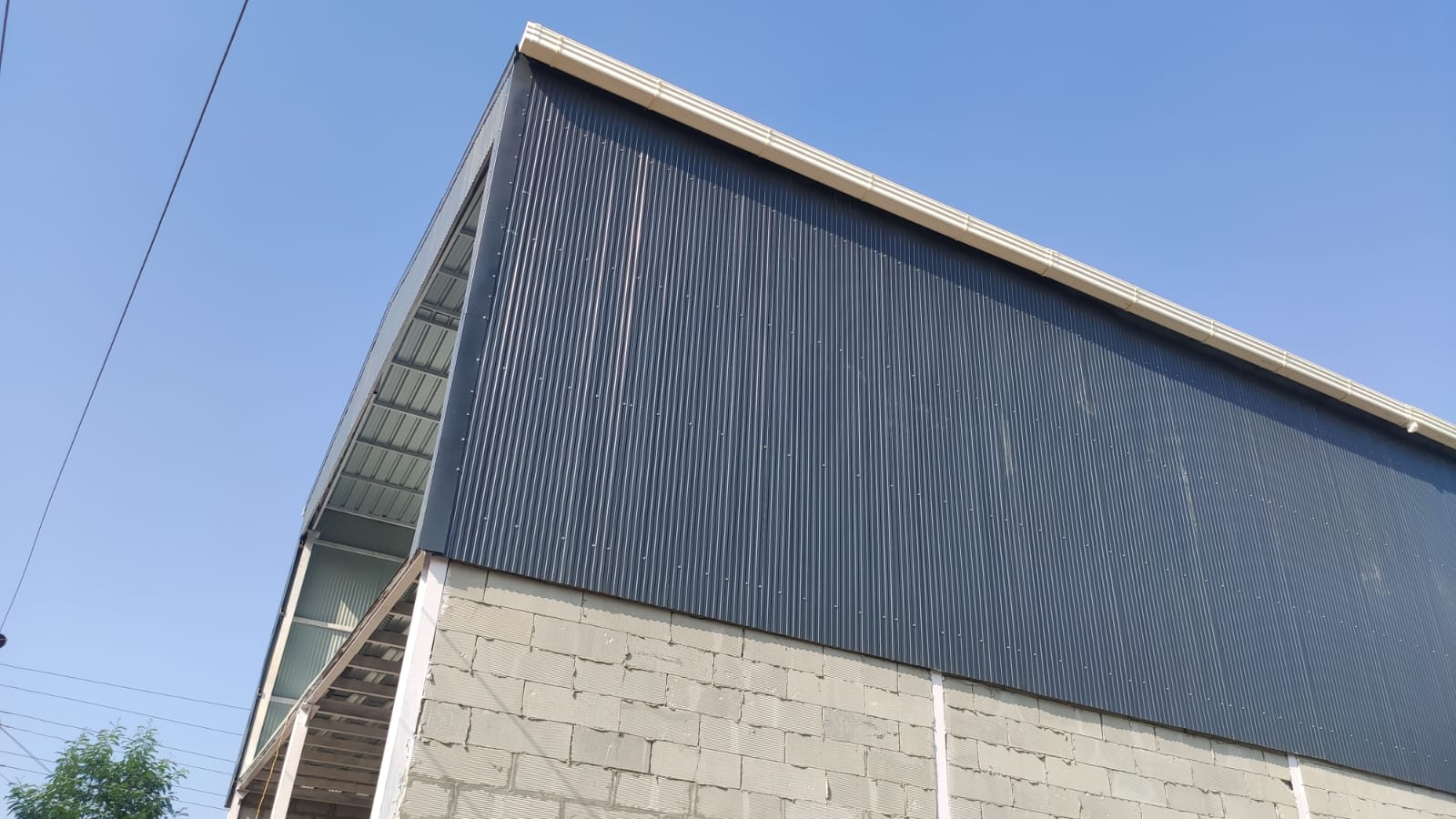 Dramatic close-up of a finished dark steel-clad building corner